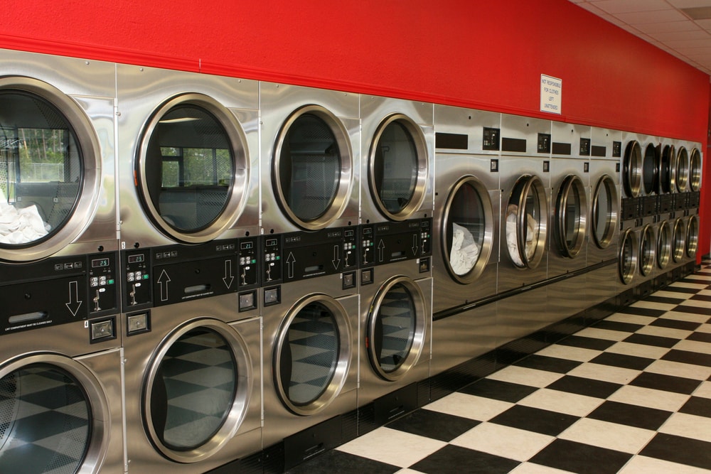 Row of dryers in a clean, bright laundromat