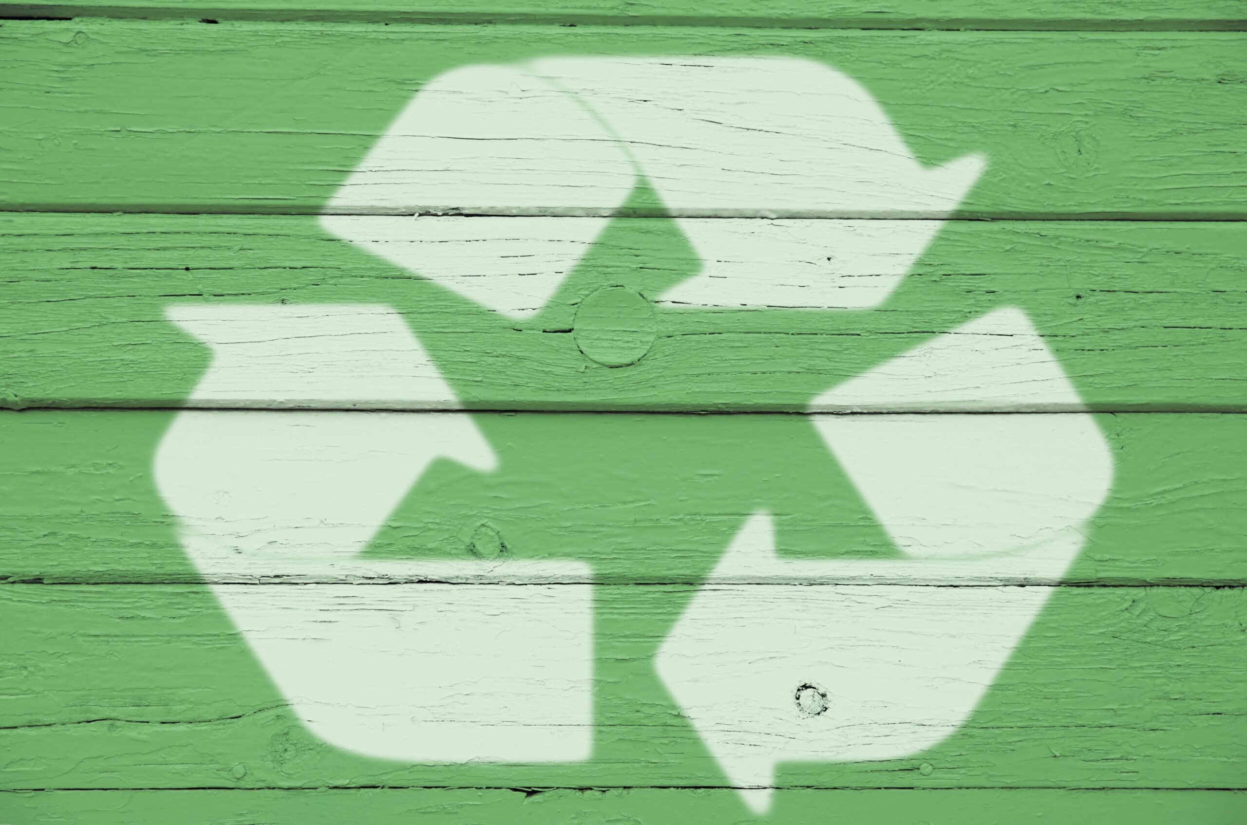 recycling sign on wood painted green